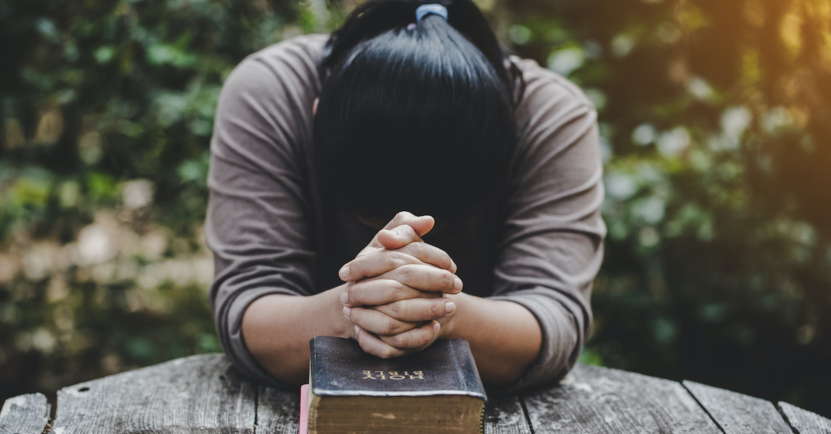 Hands folded in prayer on a Holy Bible in church concept for faith, spirituality and religion, woman praying on holy bible in the morning. woman hand with Bible praying. (Hands folded in prayer on a Holy Bible in church concept for faith, spirituality